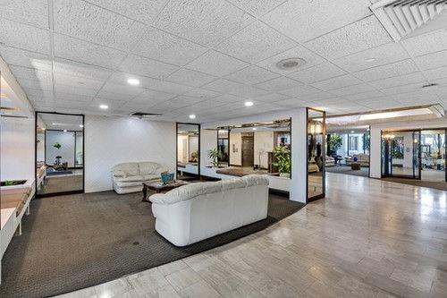 4200 Hillcrest Drive, Unit 711 Hollywood, FL 33021 - Photo 26 of 37 a living room with furniture and large windows