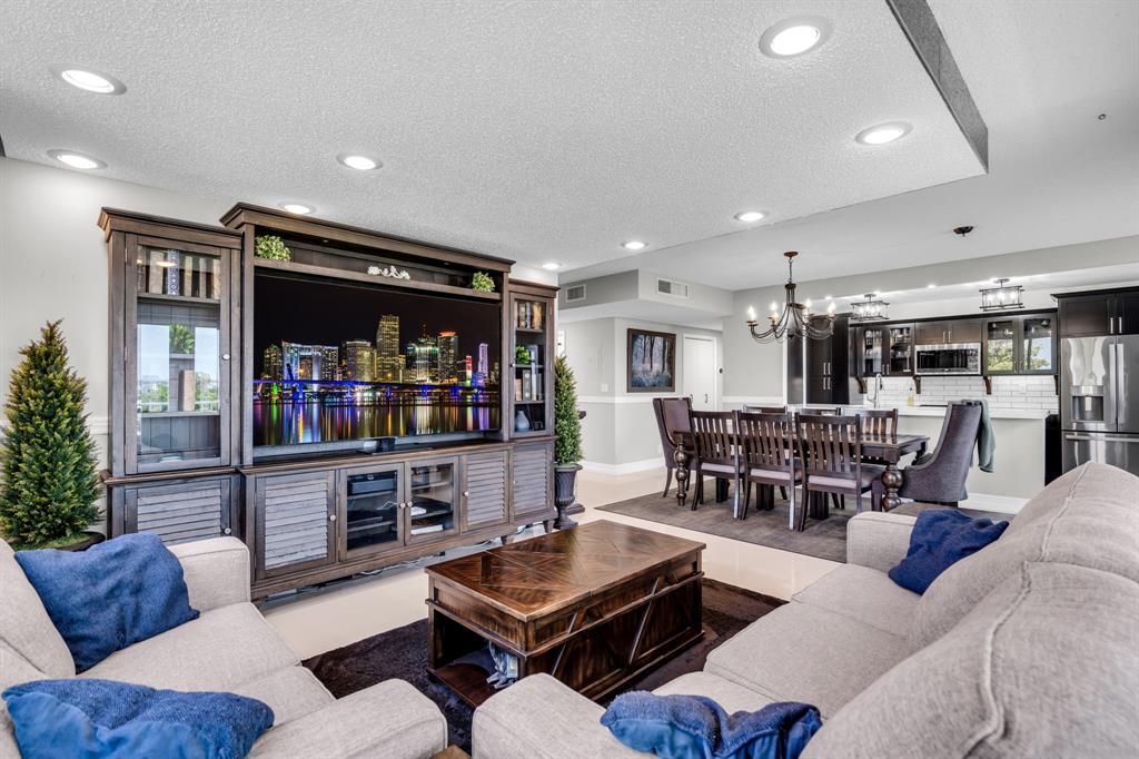 4200 Hillcrest Drive, Unit 711 Hollywood, FL 33021 - Photo 5 of 37 a living room with furniture and a flat screen tv