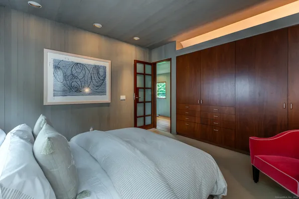 a bedroom with a bed and a couch