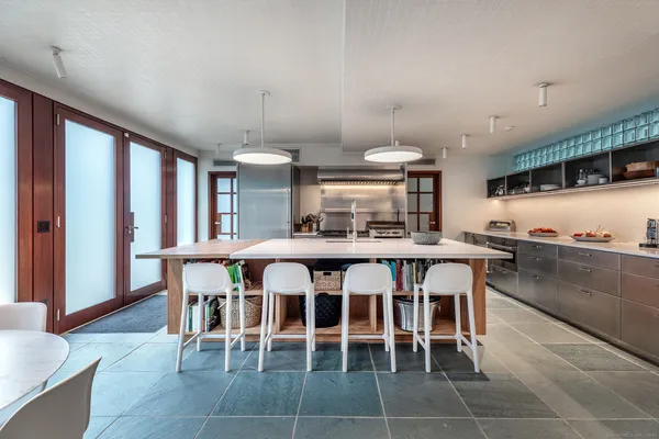 a dining room with furniture and a floor to ceiling window