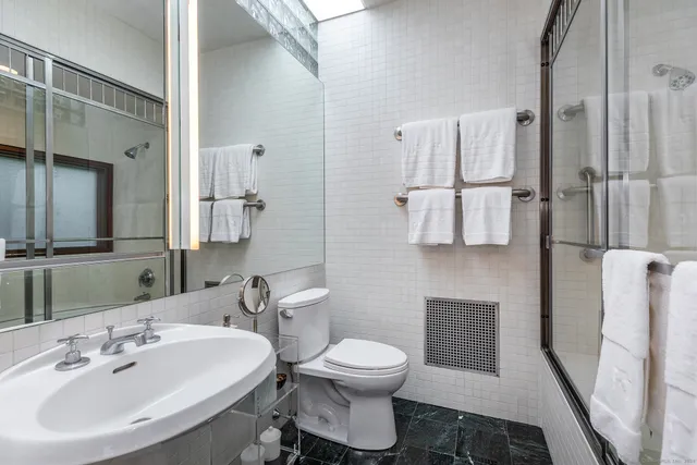 a bedroom with two beds and a large window