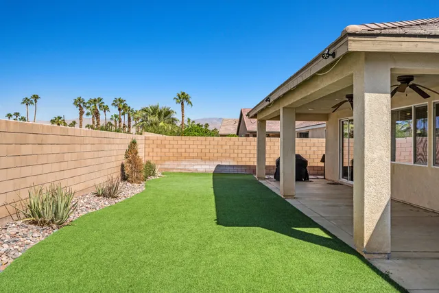 a view of a house with backyard and porch