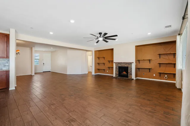 a view of a livingroom with a fireplace and a window