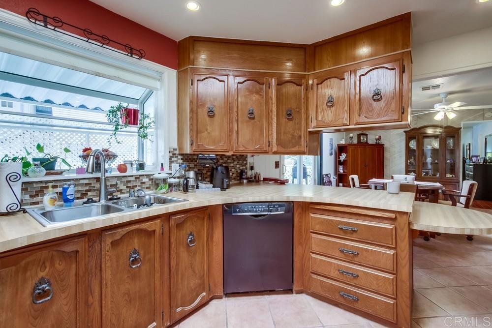1175 La Moree Road, Unit 52 San Marcos, CA 92078 - Photo 12 of 54 a kitchen with stainless steel appliances granite countertop a sink and cabinets