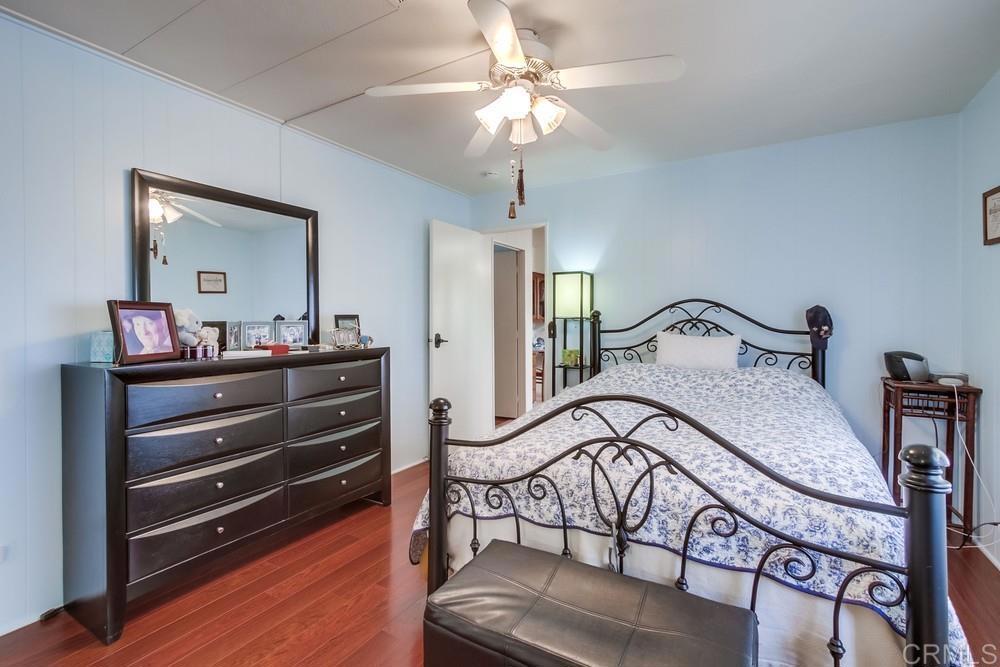 1175 La Moree Road, Unit 52 San Marcos, CA 92078 - Photo 18 of 54 a bedroom with a bed and a chandelier