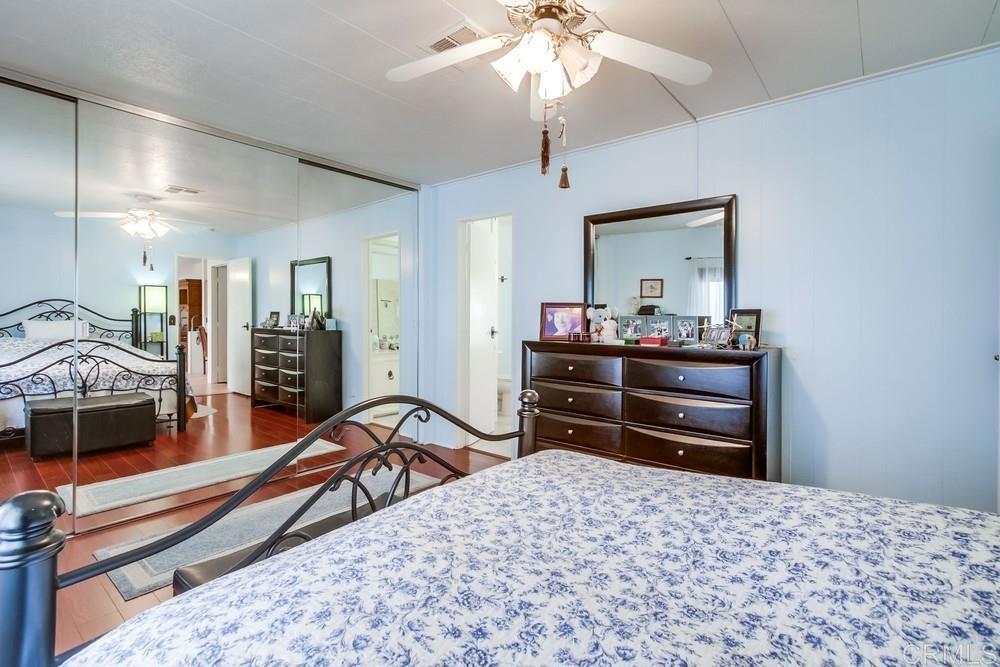 1175 La Moree Road, Unit 52 San Marcos, CA 92078 - Photo 19 of 54 a bedroom with a bed and a chandelier