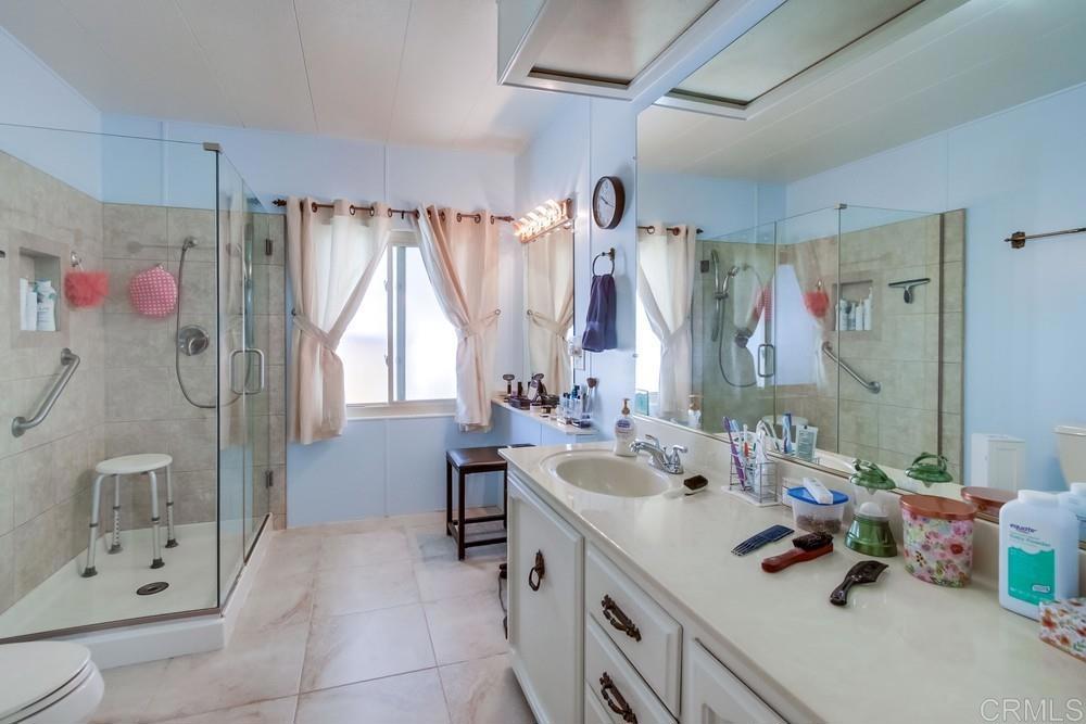 1175 La Moree Road, Unit 52 San Marcos, CA 92078 - Photo 20 of 54 a bathroom with a tub sink and mirror