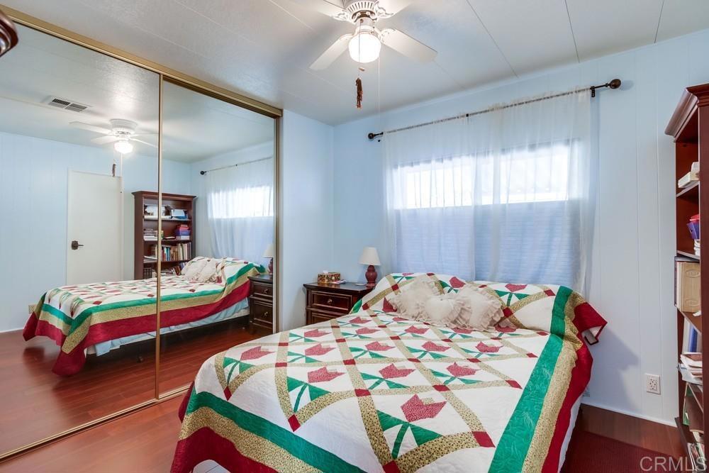 1175 La Moree Road, Unit 52 San Marcos, CA 92078 - Photo 22 of 54 a bedroom with two beds and a chandelier