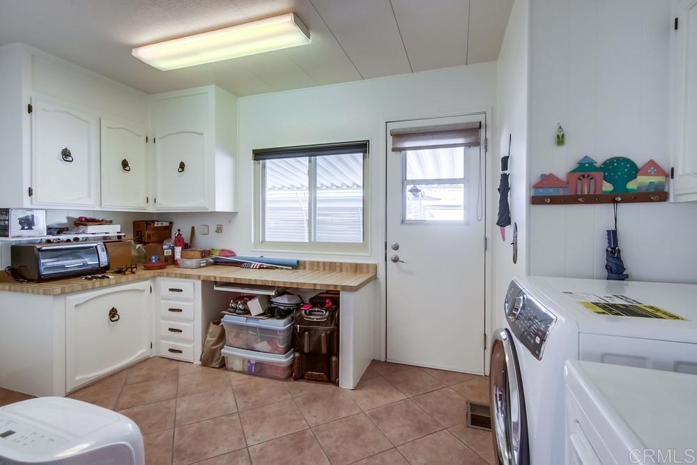 1175 La Moree Road, Unit 52 San Marcos, CA 92078 - Photo 26 of 54 a kitchen with a stove a sink and a refrigerator