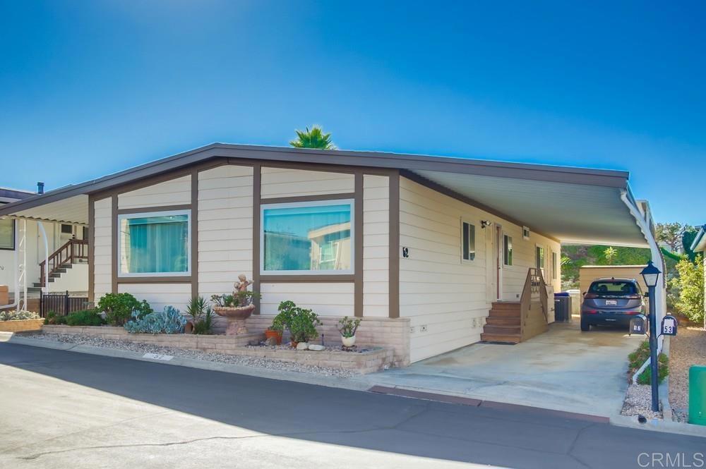1175 La Moree Road, Unit 52 San Marcos, CA 92078 - Photo 3 of 54 a front view of a house with a yard