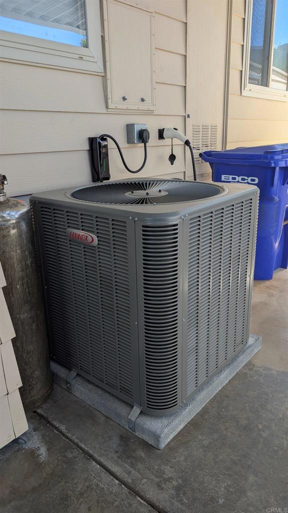 1175 La Moree Road, Unit 52 San Marcos, CA 92078 - Photo 35 of 54 a utility room with stainless steel appliances wooden cabinets washer and dryer