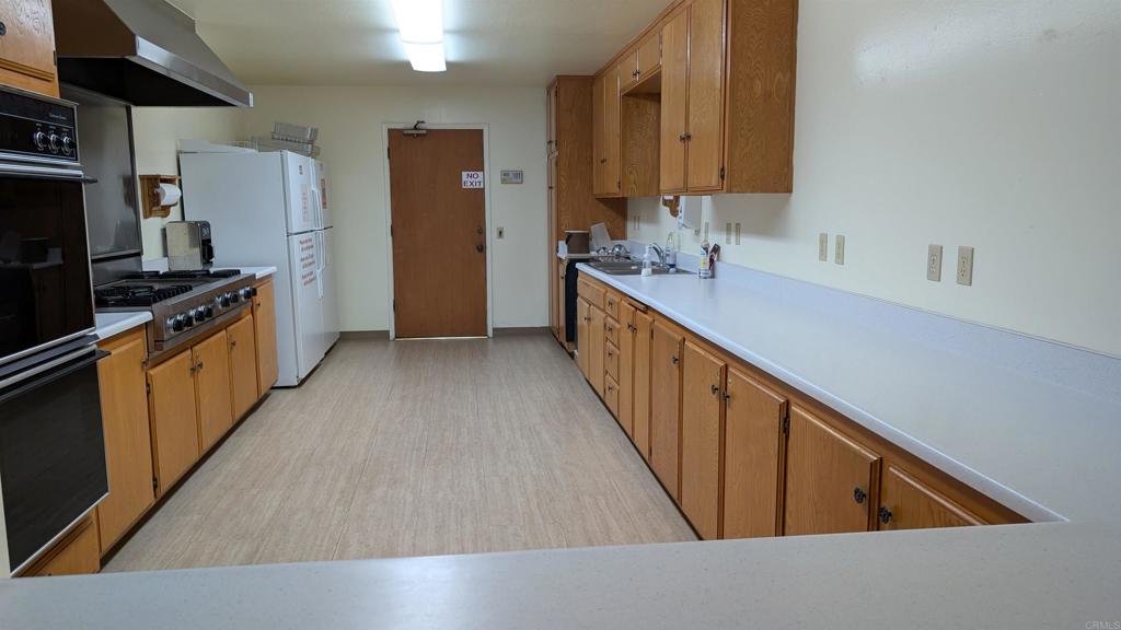 1175 La Moree Road, Unit 52 San Marcos, CA 92078 - Photo 45 of 54 a kitchen with granite countertop a sink stove and refrigerator