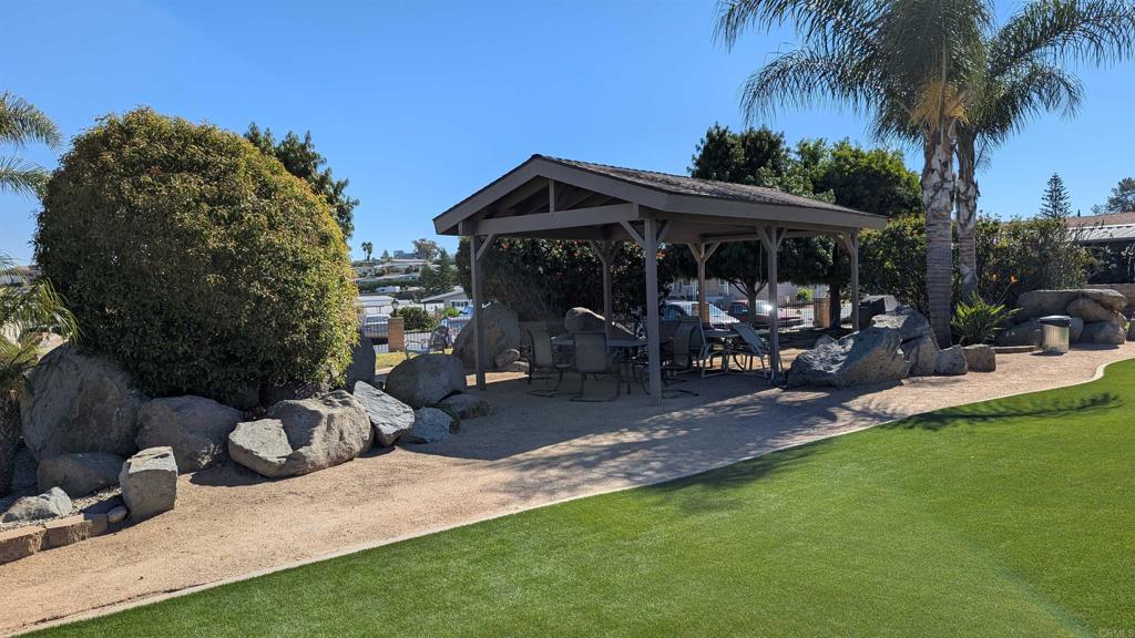 1175 La Moree Road, Unit 52 San Marcos, CA 92078 - Photo 53 of 54 a view of a patio with chair and tables back yard of the house