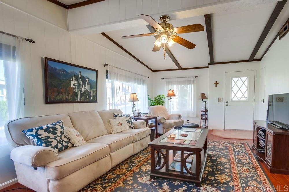 1175 La Moree Road, Unit 52 San Marcos, CA 92078 - Photo 7 of 54 a living room with furniture a chandelier and a flat screen tv