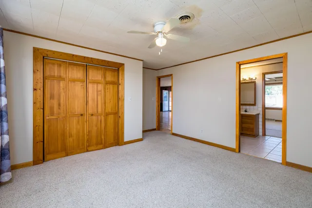 a kitchen with cabinets and wooden floor