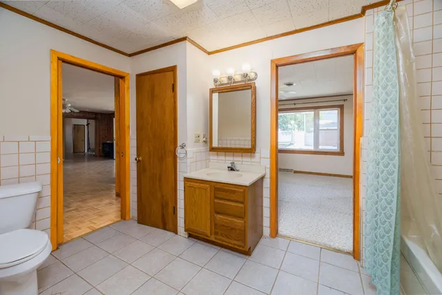a kitchen with granite countertop a stove a sink and a cabinet