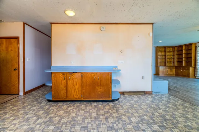 a kitchen with a refrigerator and a sink