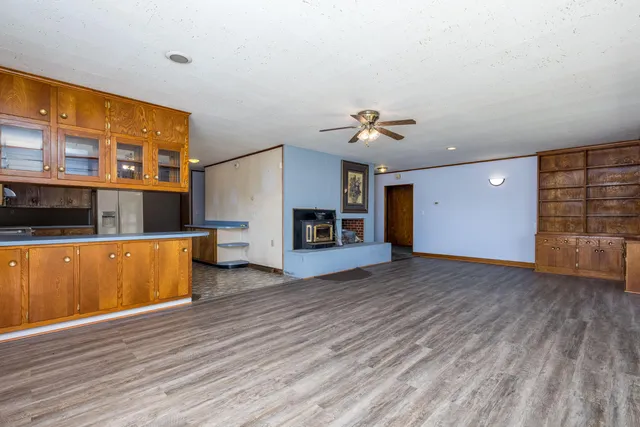 a view of green field with trees in the background