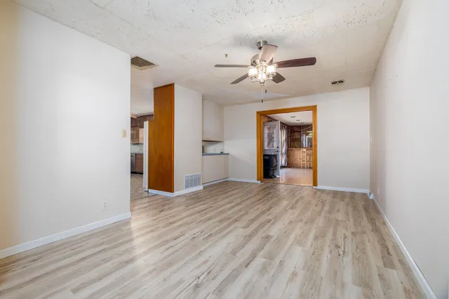 a kitchen with stainless steel appliances a stove a refrigerator a sink a microwave oven and cabinets