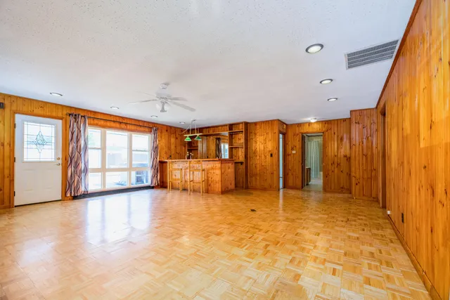 a view of room with chair and ceiling fan