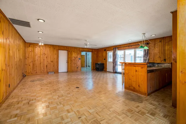 a kitchen with granite countertop a sink cabinets stainless steel appliances and a window