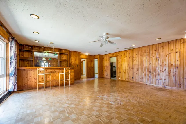 an empty room with closet and a ceiling fan