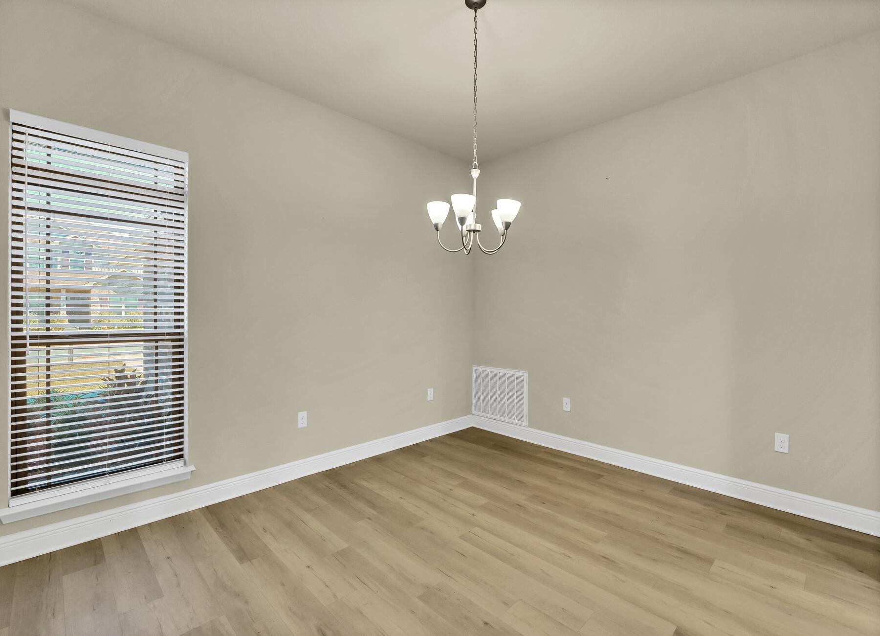 3639 Ranch Drive Crestview, FL 32539 - Photo 17 of 84 a view of empty room with wooden floor and fan