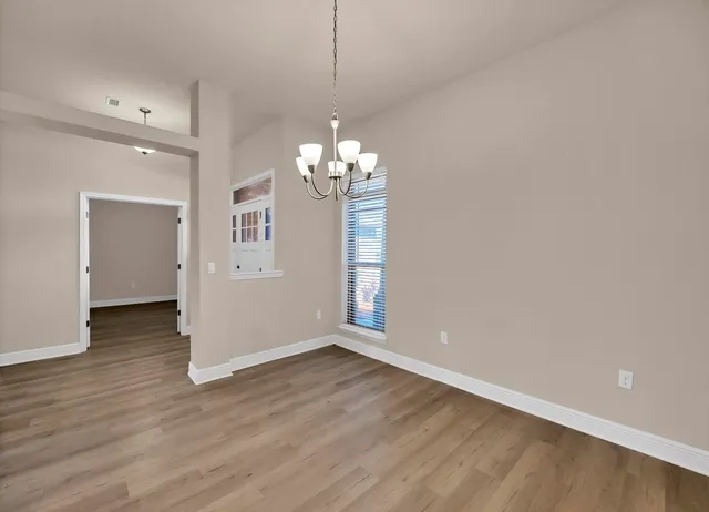 a view of kitchen with granite countertop stainless steel appliances sink and cabinets