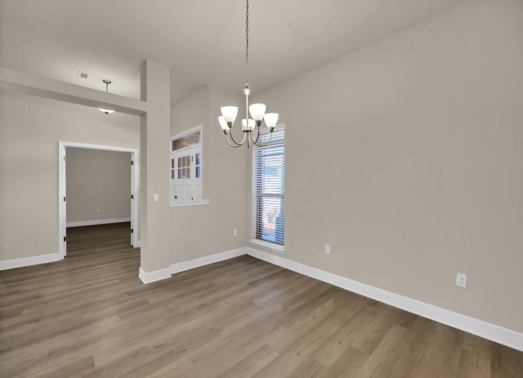 3639 Ranch Drive Crestview, FL 32539 - Photo 20 of 84 wooden floor in an empty room with a window