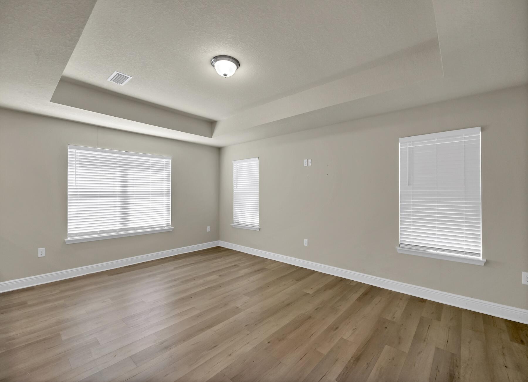 3639 Ranch Drive Crestview, FL 32539 - Photo 31 of 84 a view of an empty room with wooden floor and a window
