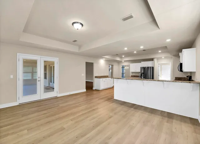 wooden floor in an empty room and a ceiling fan