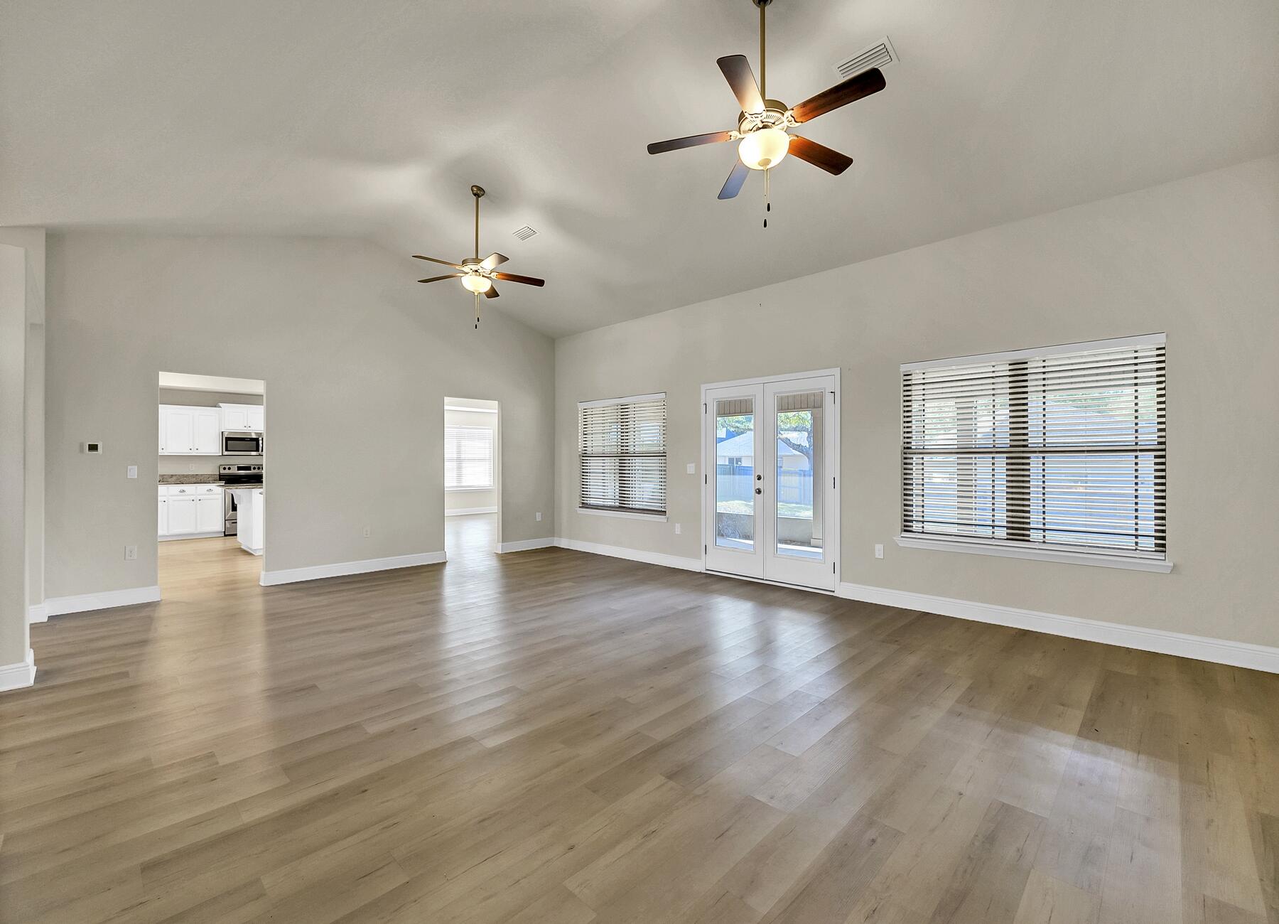 3639 Ranch Drive Crestview, FL 32539 - Photo 44 of 84 a view of an empty room with a window and wooden floor