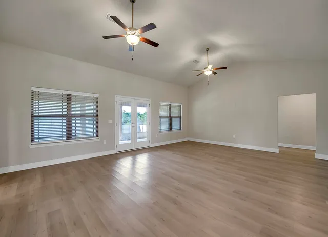 a bathroom with a granite countertop sink a large mirror and shower