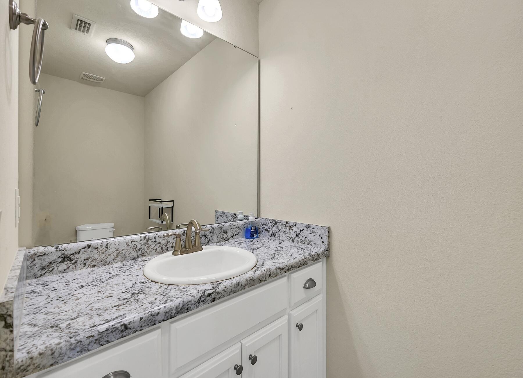 3639 Ranch Drive Crestview, FL 32539 - Photo 70 of 84 a bathroom with a granite countertop sink and a mirror