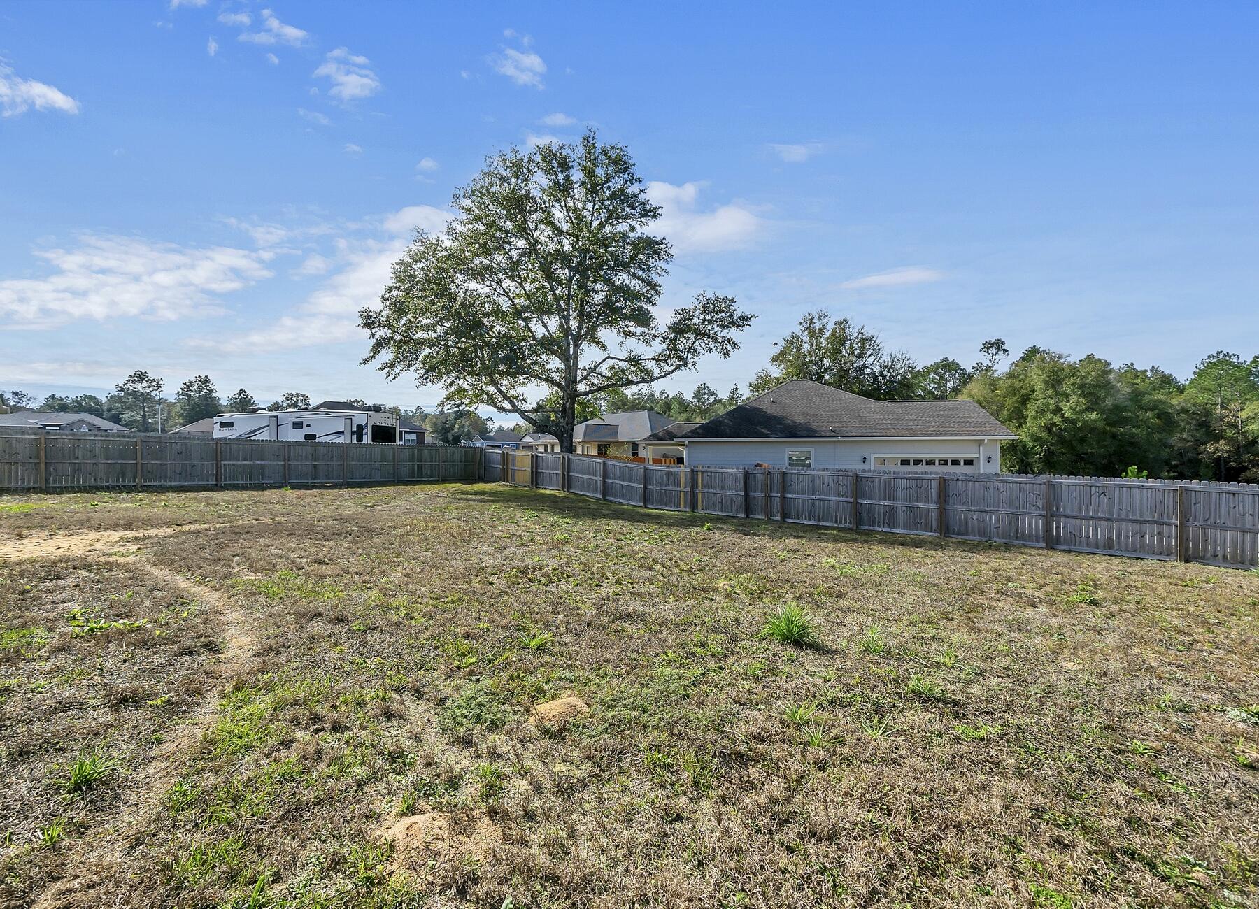 3639 Ranch Drive Crestview, FL 32539 - Photo 7 of 84 a backyard of a house with lots of green space