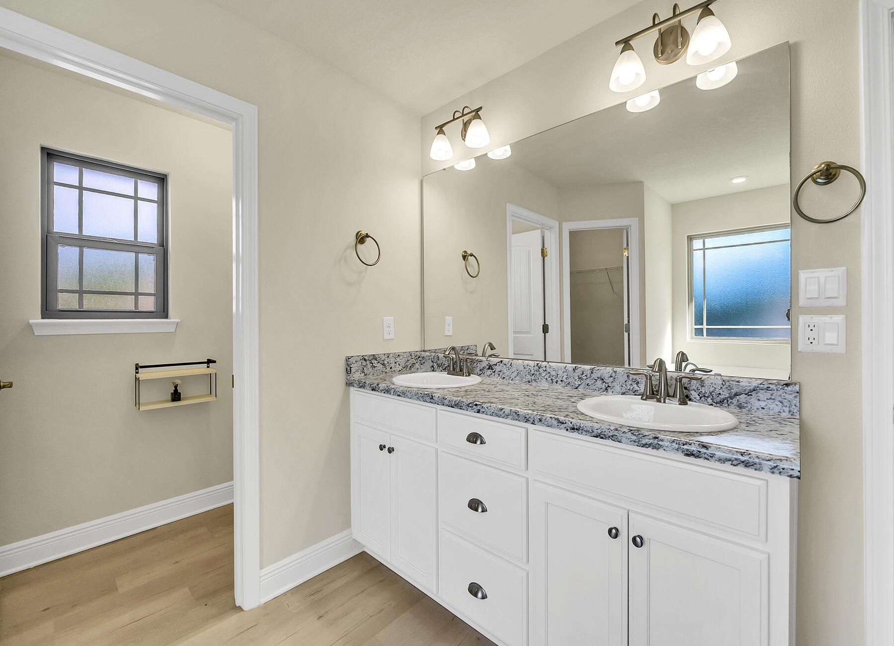 3639 Ranch Drive Crestview, FL 32539 - Photo 72 of 84 a bathroom with a granite countertop sink a large mirror and a shower