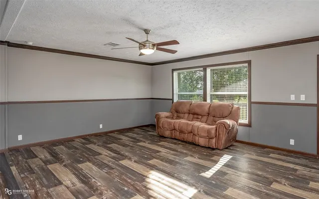 a living room with a bed furniture and a window