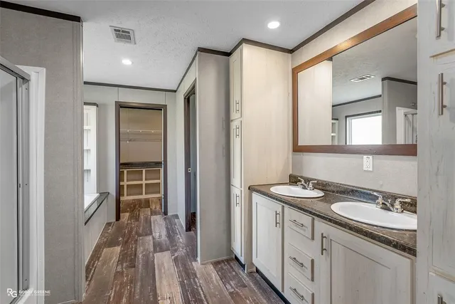 a spacious bathroom with a sink and a mirror