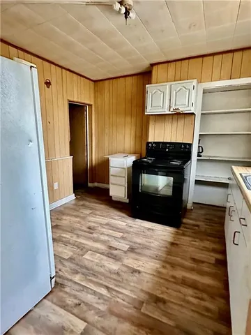 a living room with a fireplace furniture and a ceiling fan