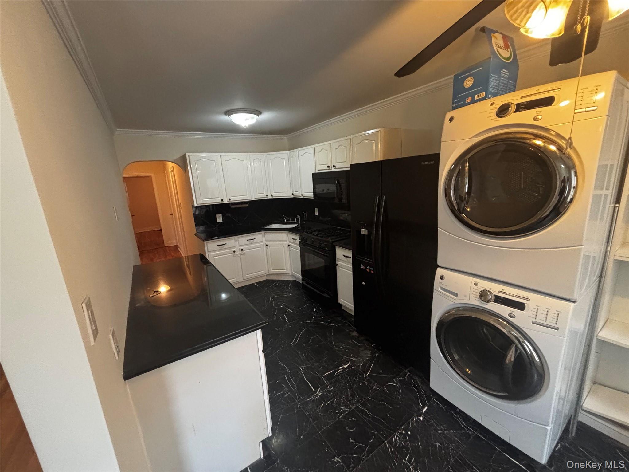 253-29 85th Road Queens, NY 11426 - Photo 4 of 8 a view of a kitchen with washer and dryer