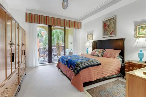 a bedroom with a bed lamp and a window