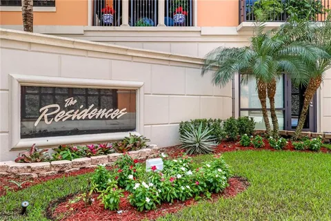 a view of sign board with flower plants
