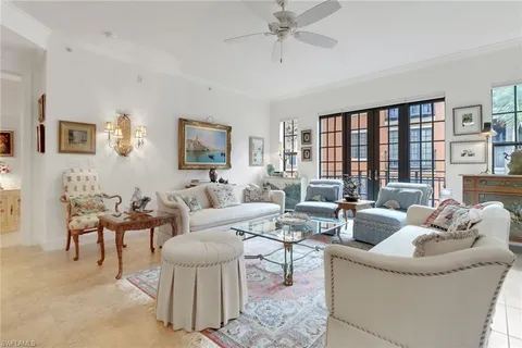 a living room with furniture and kitchen view