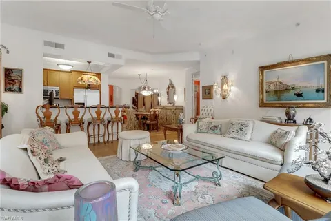 a view of a dining room with furniture and a chandelier