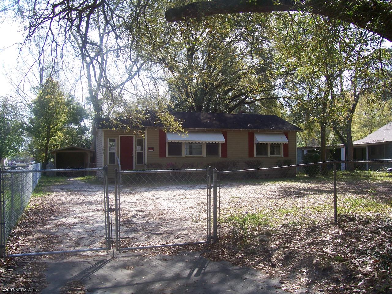 7657 Calvin Street Jacksonville, FL 32208 - Photo 1 of 8 a backyard of a house with lots of green space