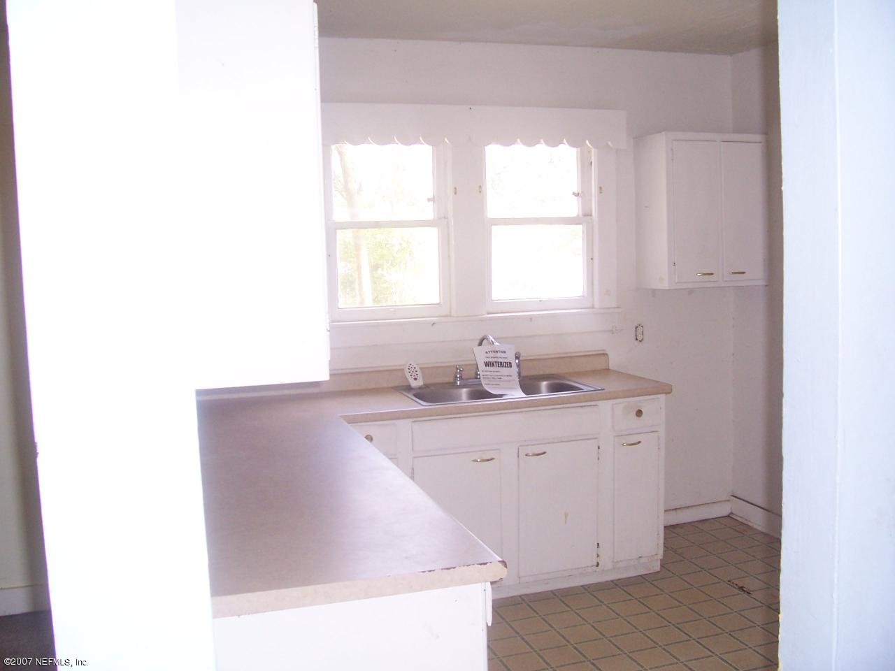 7657 Calvin Street Jacksonville, FL 32208 - Photo 3 of 8 a kitchen with sink and window