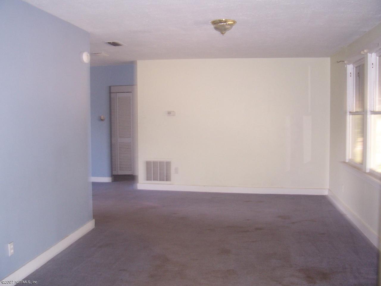 7657 Calvin Street Jacksonville, FL 32208 - Photo 4 of 8 a view of an empty room with a window
