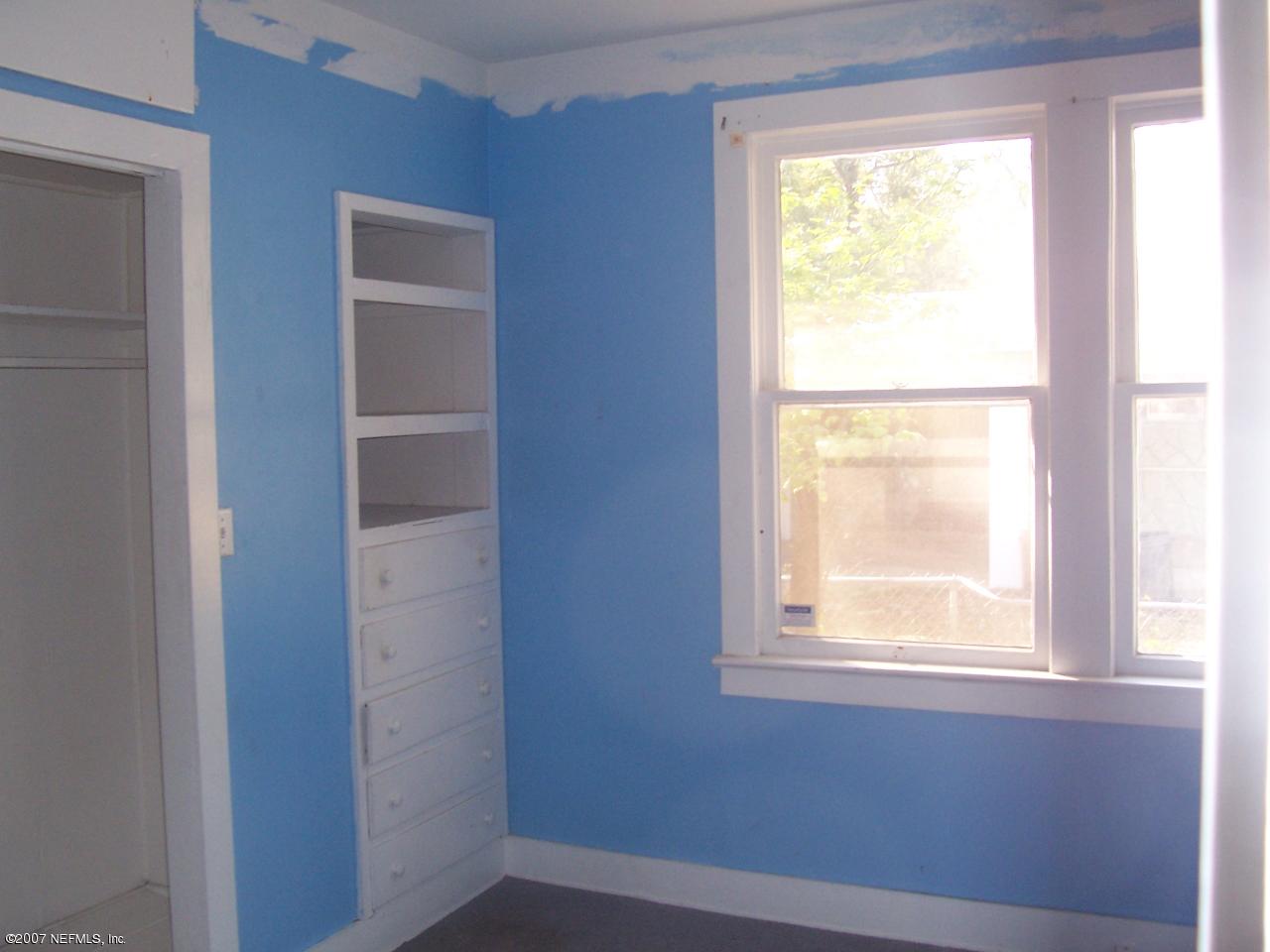 7657 Calvin Street Jacksonville, FL 32208 - Photo 5 of 8 a view of an empty room with a window