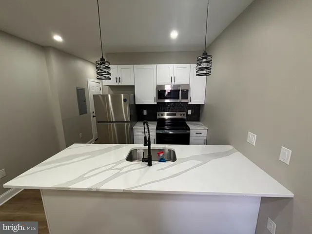 a large kitchen with a table and chairs