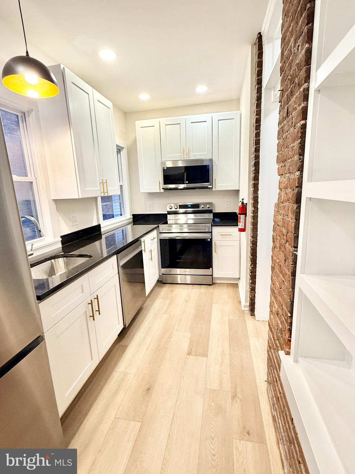 123 North Hanover Street, Unit 1 Pottstown, PA 19464 - Photo 1 of 22 a kitchen with stainless steel appliances a stove a sink and a refrigerator